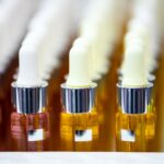 Set of cosmetic bottles in rows, equipment for beauty store