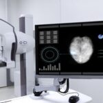 A mammogram machine showing breast cancer image on a computer monitor.